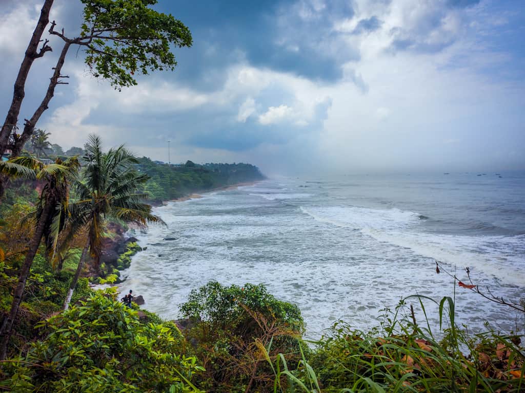 View of beach with water from a cliff Kerala Itinerary