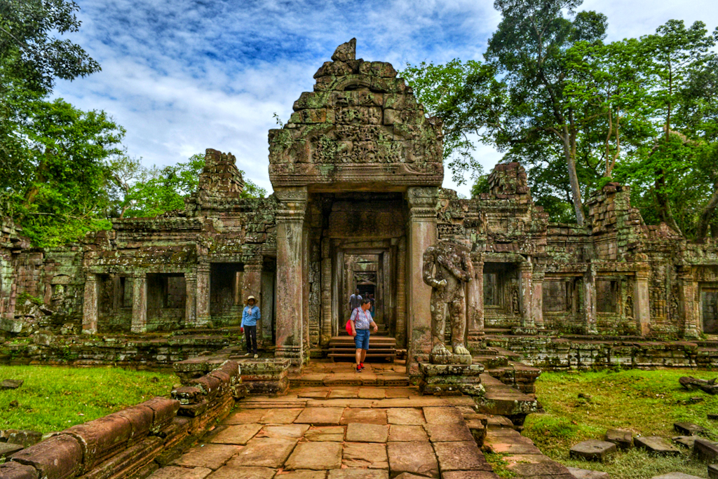 people entering temple ruins 