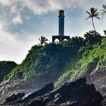 Lighthouse on a cliff surrounded by green plants and trees Sri Lanka Itinerary