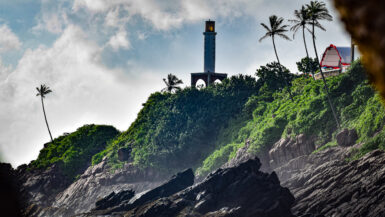 Lighthouse on a cliff surrounded by green plants and trees Sri Lanka Itinerary