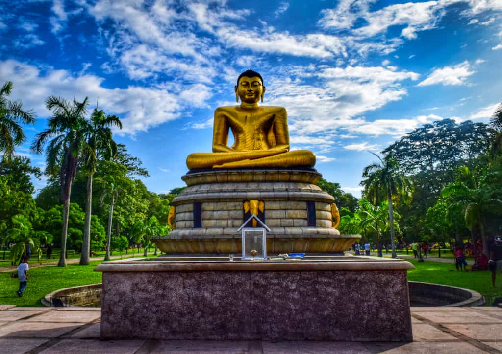 Gold statue of Buddha in a park