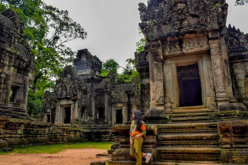 girl standing in front of a temple cambodia travel