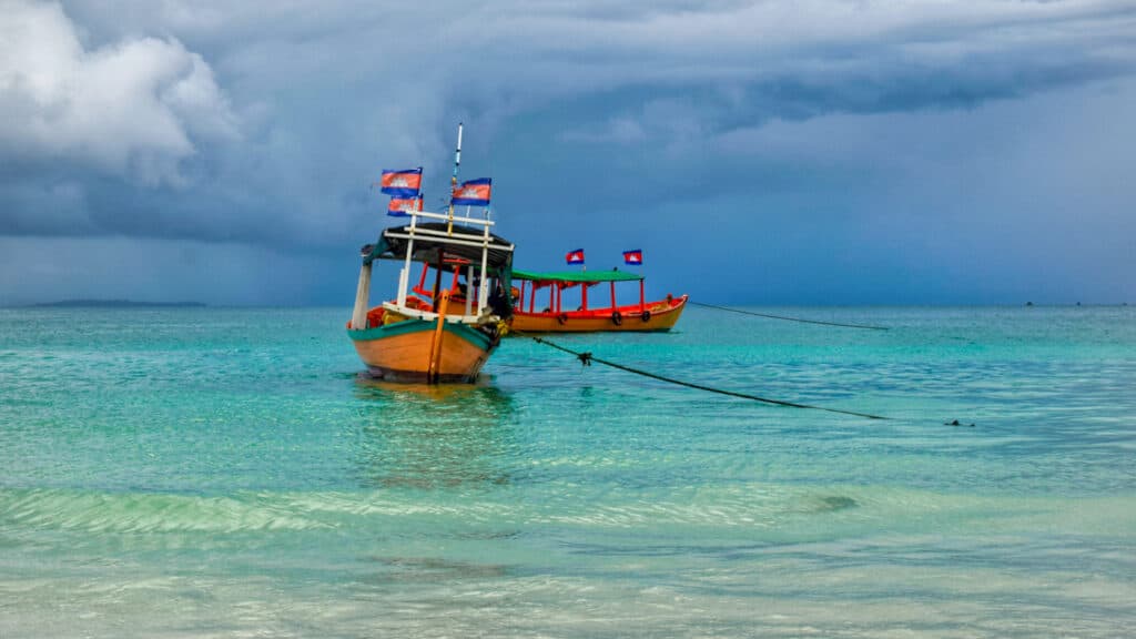 Colorful boat docked in the ocean India to Cambodia Itinerary