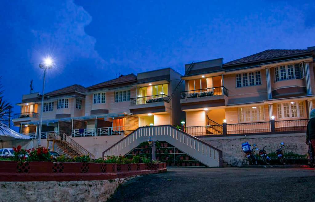 Exterior of a hotel during night delightz inn resort ooty