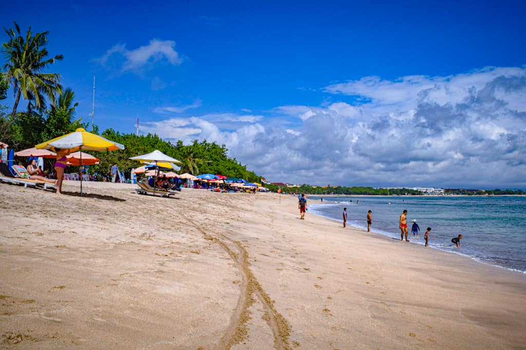 beach with colorful umbrellas and people