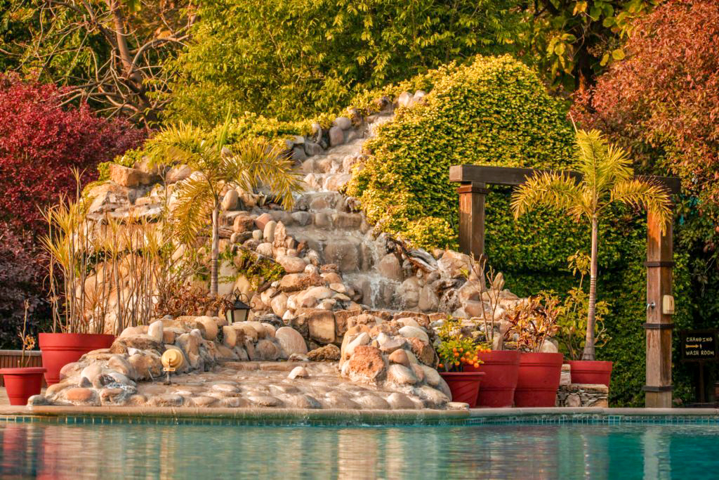 Close up on waterfall in a swimming pool aahana resort ramnagar