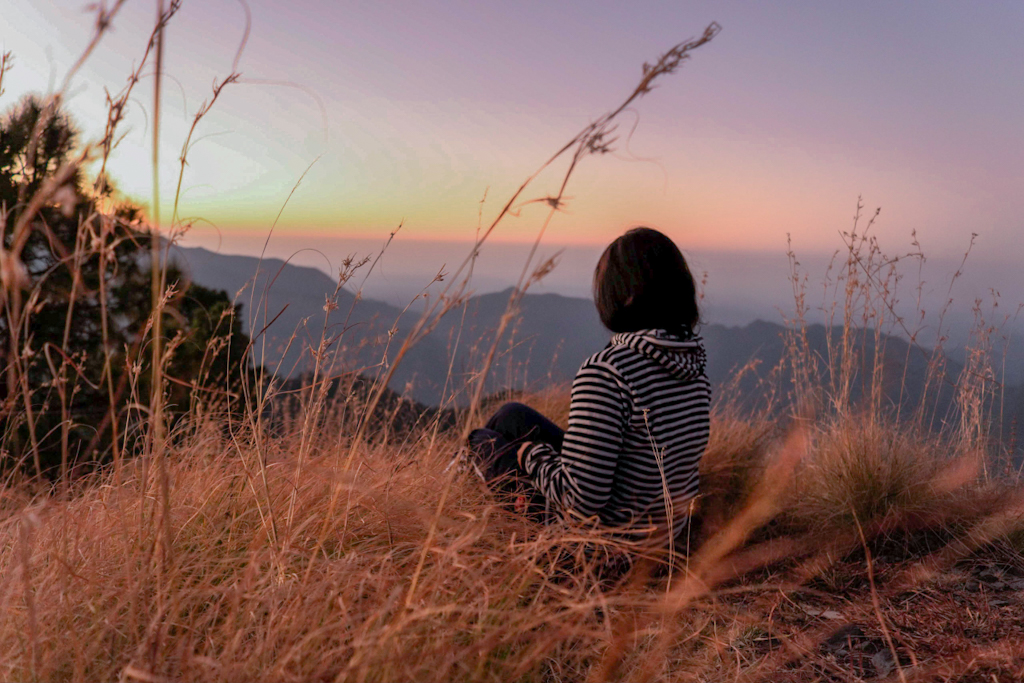 girl sitting on a mountain