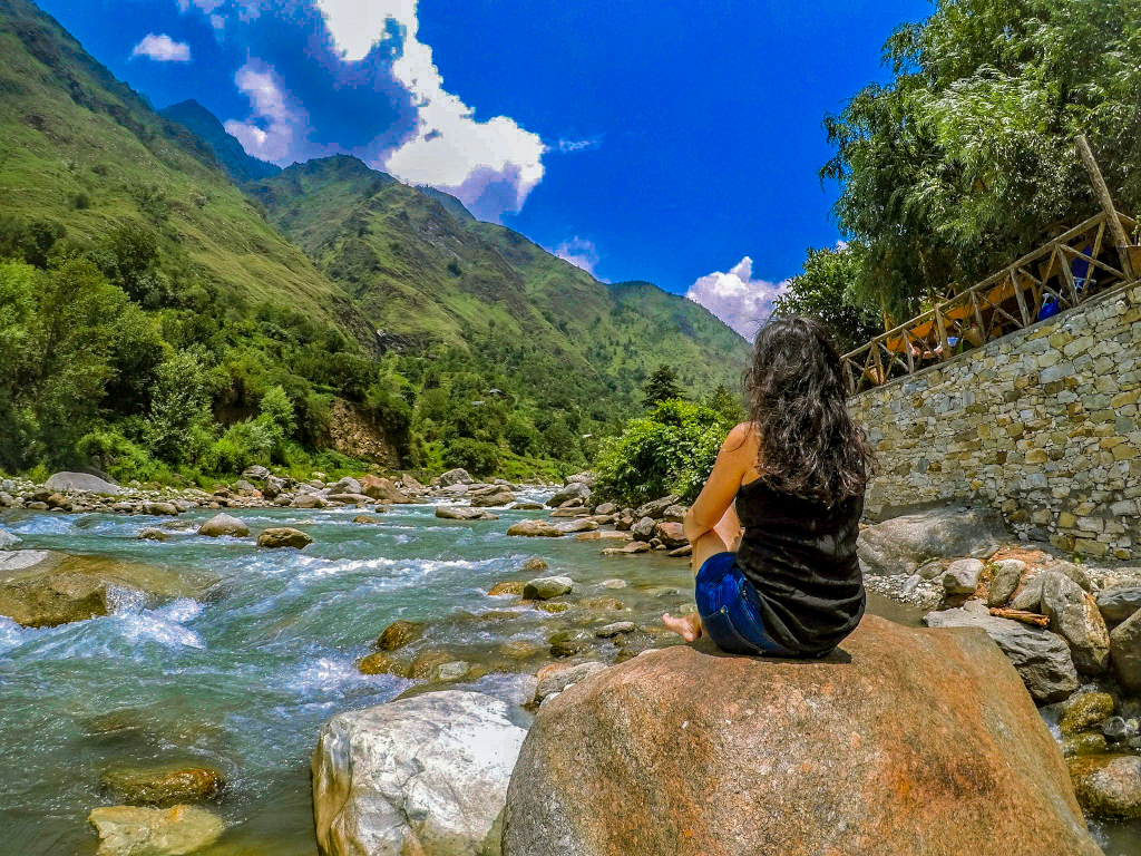 girl sitting beside a river digital nomad