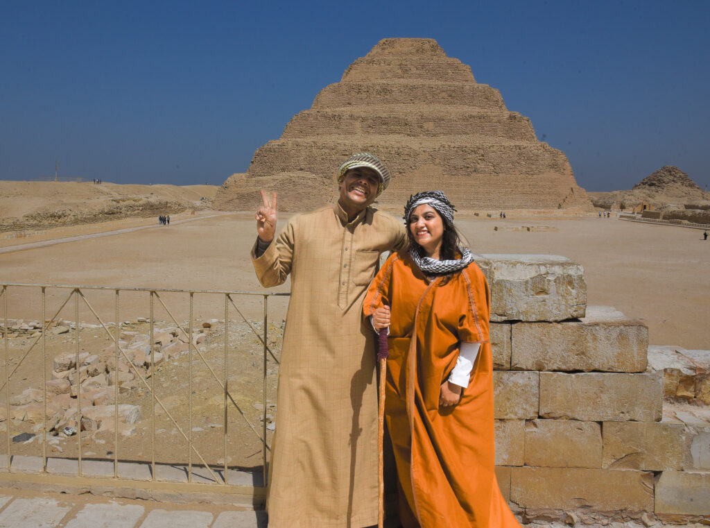 indian girl and egyptian guy in front of pyramid