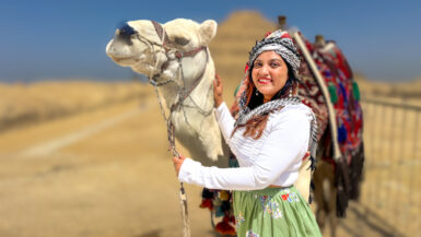 indian girl standing with a camel in front of a pyramid egypt visa for indians